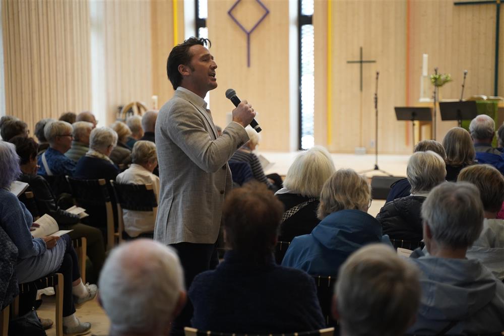 Opersanger som synger, han er ute på kirkegulvet blant publikum. - Klikk for stort bilde