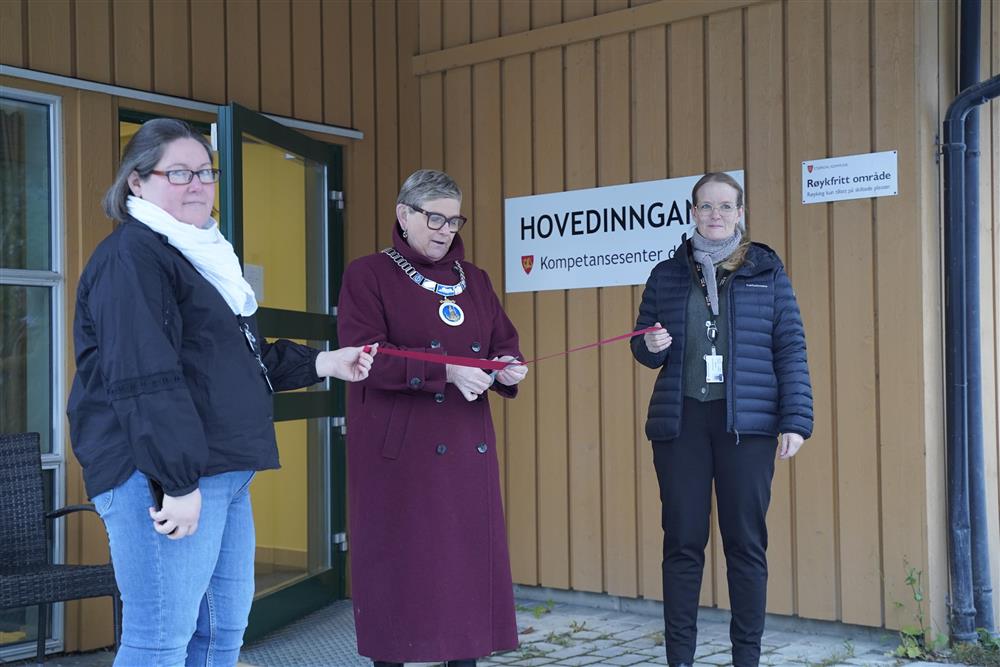 Ordfører Eli Arnstad klipper snoren og erklærer kompetansesenteret for åpnet. Det foregår utendørs foran hovedinngangen til kompetansesenter demens - Klikk for stort bilde