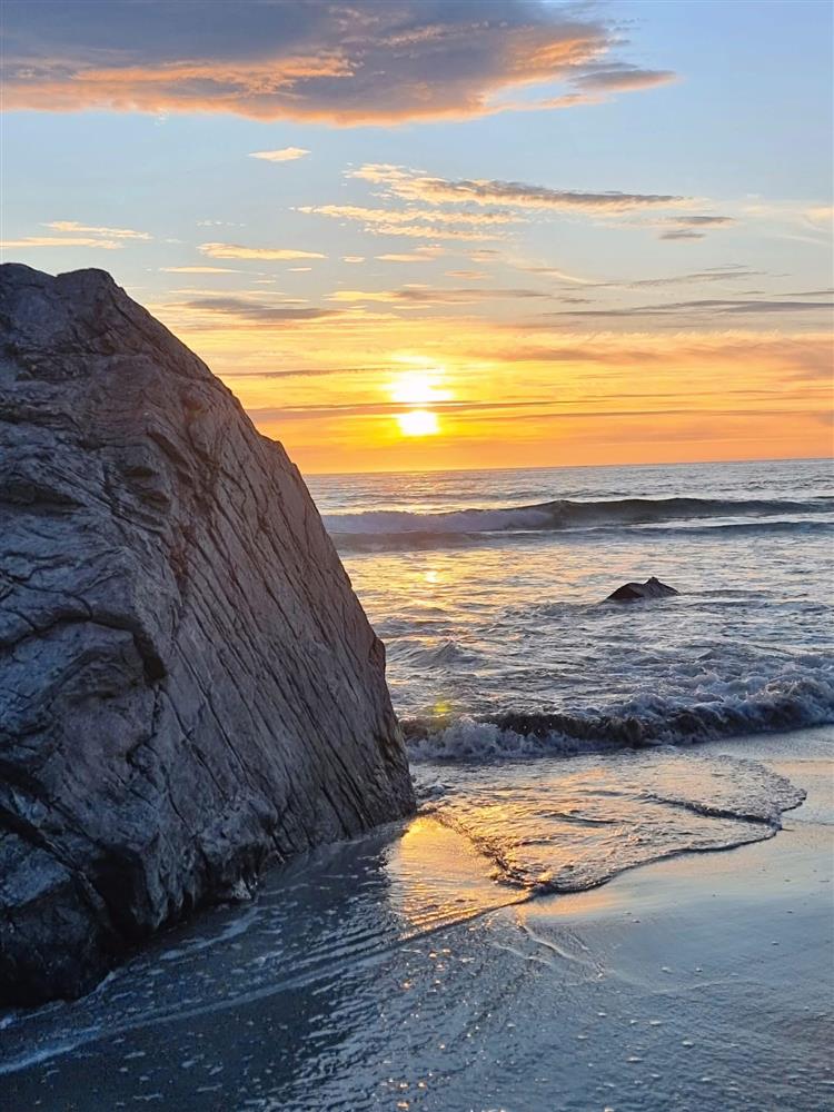 Solnedgang på en strand - Klikk for stort bilde