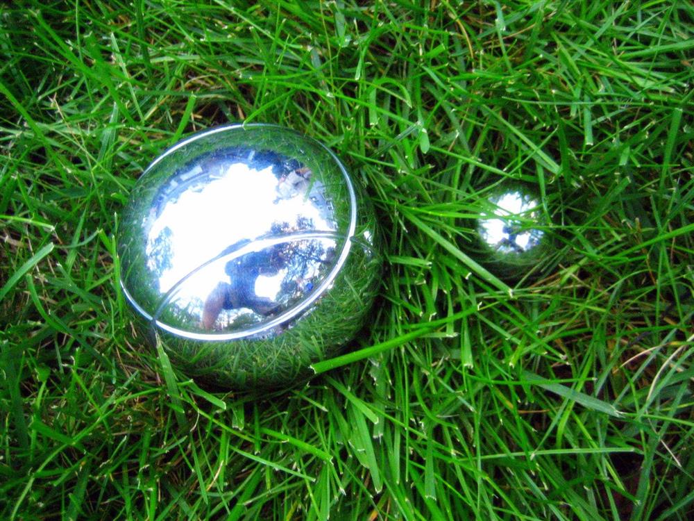 Nærbilde av to petangue kuler som ligger i gresset - Klikk for stort bilde